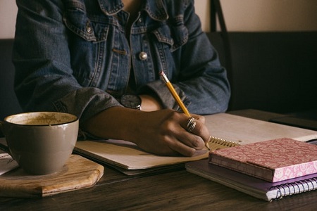 Girl Writing Content In Bluejean Jacket