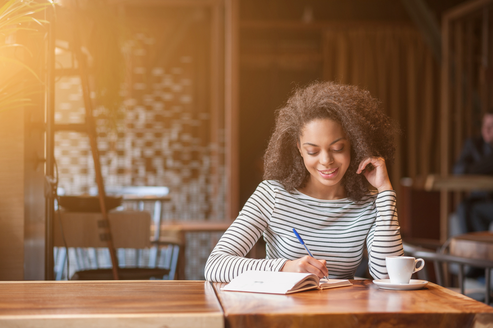 Woman Writing In Book